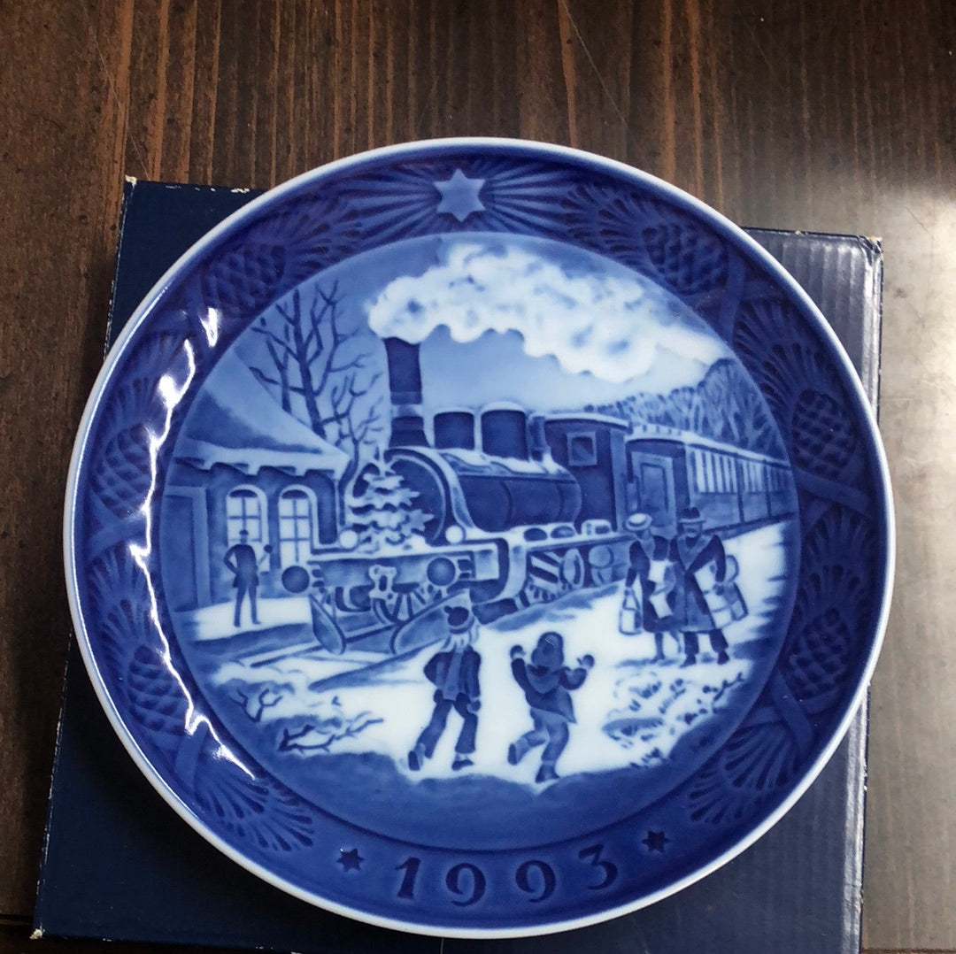 Picture of: 1993 Royal Copenhagen Christmas Plate depicting a steam train decorated for the season and children at play