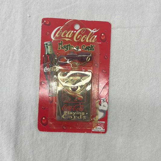 1999 vintage Coca-Cola playing cards (collaboration with Bicycle) with antique polar bear design and purple keychain. Still in original sealed packaging. Plastic has yellowed due to age.